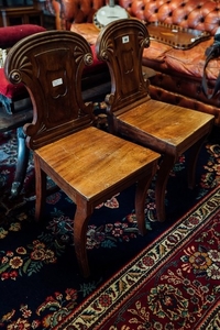 Pair of Regency mahogany hall chairs.