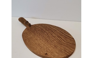 Robert Thompson, a Mouseman oak cheese board, of typical for...