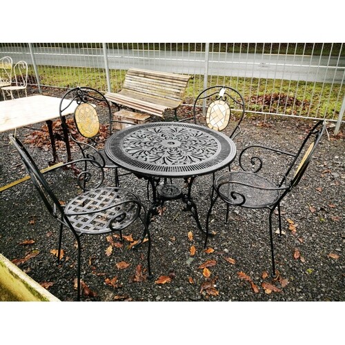 Set of four wrought iron garden chairs and matching table.