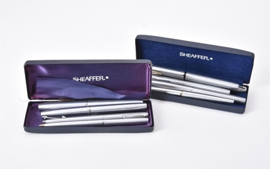 Sheaffer, a collection of nine white metal pens