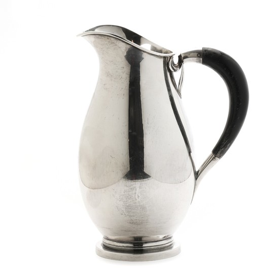 Silver milk jug, baluster-shaped, side with black painted wooden handle. Makers mark Theodor Sabroe. Copenhagen city mark 1950. Weight 450 gr H. 20 cm.