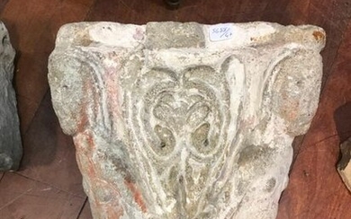 Small carved limestone capital with characters decoration