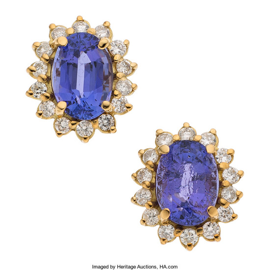 Tanzanite, Diamond, Gold Earrings The earrings feature oval-shaped tanzanite,...