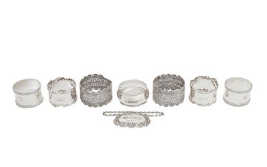 Two pairs of Edwardian and Elizabeth II silver napkin rings,...