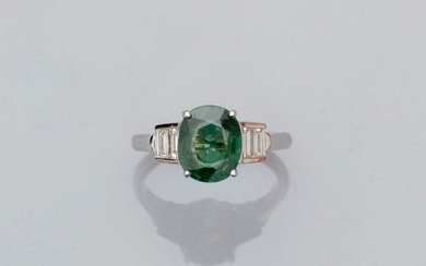 White gold ring, 750 MM, set with a treated oval green sapphire weighing 2.54 carats between two lines of baguette-cut diamonds, GGT laboratory certificate, size: 54, weight: 3.6gr. rough.