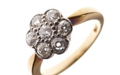 Yellow metal and diamond cluster ring of seven stone...