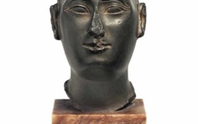 AN EGYPTIAN GREYWACKE HEAD OF A PRIEST, LATE PERIOD, 26TH DYNASTY, REIGN OF AHMOSE, CIRCA 570-526 B.C.