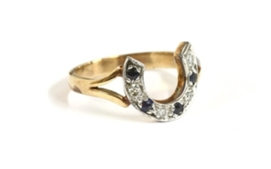 A gold diamond and sapphire horseshoe ring