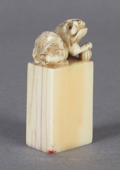A CHINESE CARVED IVORY SEAL modelled as a Dog of Fo, its rig...