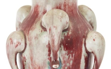 A Chinese flambé glazed vase, late Qing dynasty, of baluster form decorated with stylised elephant masks to the body, with streaked glaze in tones of red and white, 19cm high 清晚期 窯變釉瓶