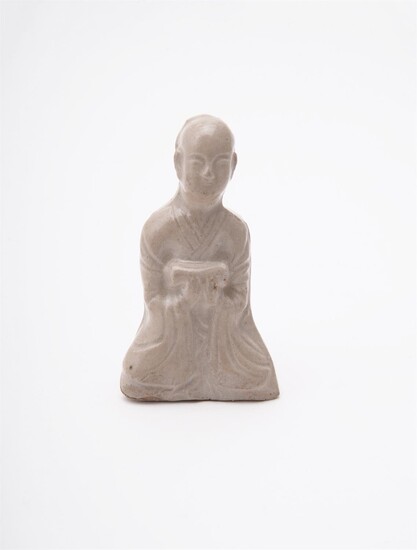 A Chinese press-moulded figure of a seated scholar