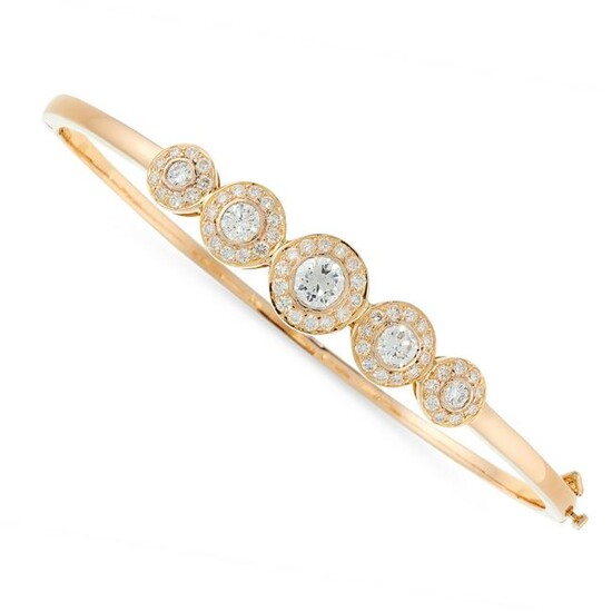 A DIAMOND BANGLE in 18ct yellow gold, set with a row of