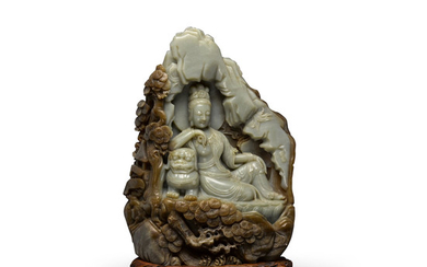 A GREEN AND BROWN JADE GUANYIN GROTTO