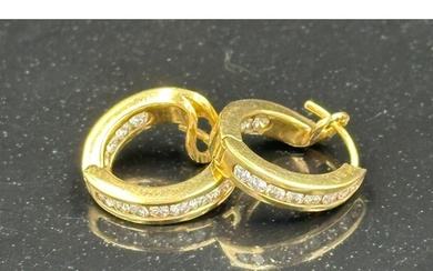 A Gold diamond hoop earrings mounted in 18ct gold. Signed T&...