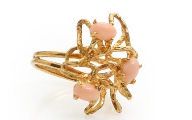 A Italian coral ring set with three cabochon-cut corals, mounted in 18k...