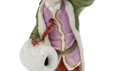 A Ludwigsburg porcelain figure emblematic of Winter, c.1765, blue crowed interlaced C mark, incised mark, modelled by Joseph Nees, wearing a turban and fur-lined green cloak, his right hand in a muff, standing on a gilt-edged scroll-moulded mound...