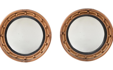 A PAIR OF GILTWOOD CIRCULAR CONVEX WALL MIRRORS IN LATE GEORGE III STYLE