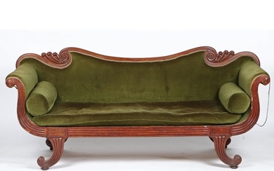A Regency mahogany and upholstered settee, having a wavy cre...