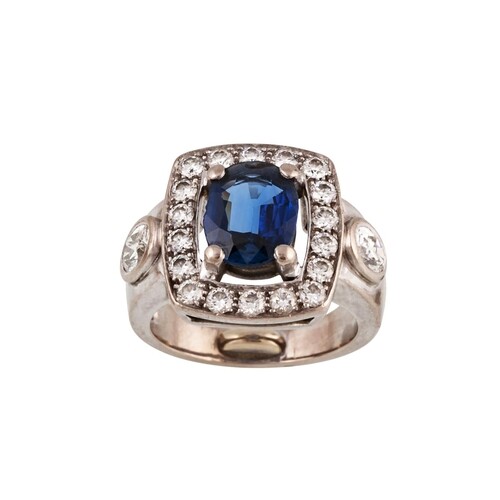 A SAPPHIRE AND DIAMOND CLUSTER RING, the oval sapphire to a ...