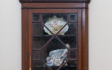A Victorian Georgian style hanging corner cabinet with panelled glass door and shelved interior, some veneer rising., Height 110cm x Width 50cm x Depth 26.5cm