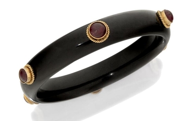 A black onyx and ruby bangle, set with six cabochon ruby collets, inner circumference approx. 6.5cm