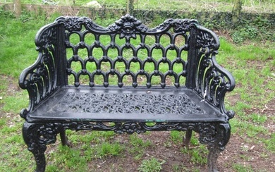 A good quality heavy gauge cast iron two seat garden bench w...