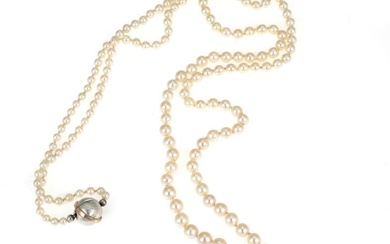 A graduated pearl necklace set with numerous Akoya salt water cultured pearls...