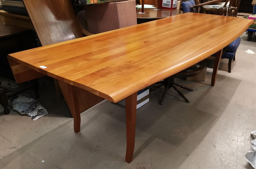 A large modern wakes style table in cherrywood, with shaped ...
