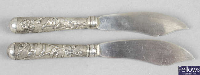 A pair of Chinese export silver butter knives, plus various foreign spoons (low grade). (20).