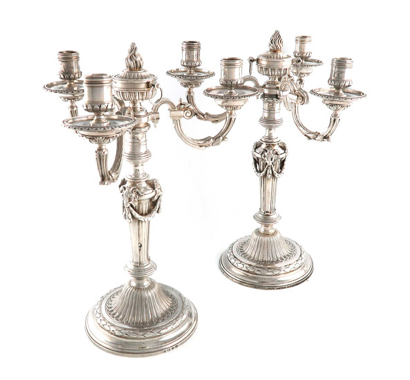 A pair of George III and Victorian silver three-light candelabra with associated branches