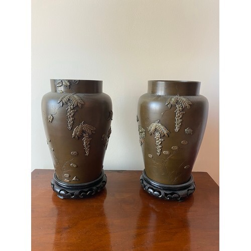 A pair of Japanese bronze vases, the bodies decorated with b...