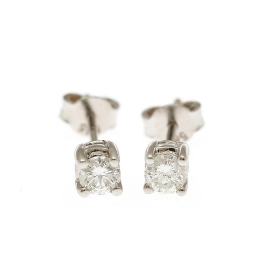 A pair of diamond solitaire ear studs each set with a brilliant-cut diamond totalling app. 0.40 ct., mounted in 14k white gold. (2)