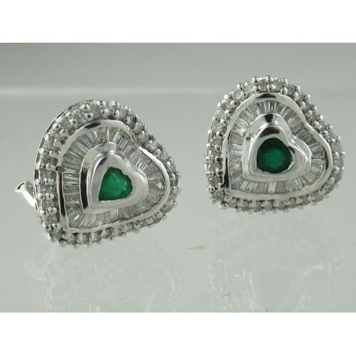 A pair of heart shaped emerald and diamond earrings, the hea...