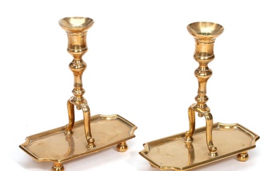 A pair of probably Spanish 18th/19th century brass 'stirrup' candlesticks on rectangular...