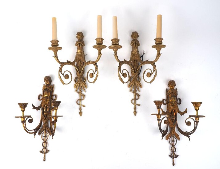 A set of four gilt-bronze twin-light wall appliques, late 20th century, the backplates modelled as trumpet-playing cherubs, 41cm high (4) It is the buyer's responsibility to ensure that electrical items are professionally rewired for use.