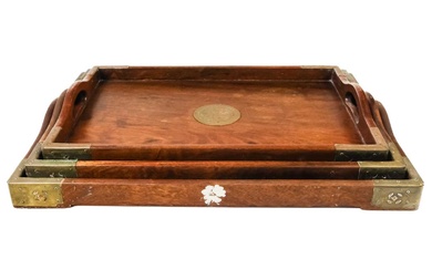 A set of three graduated Chinese hardwood and brass trays.