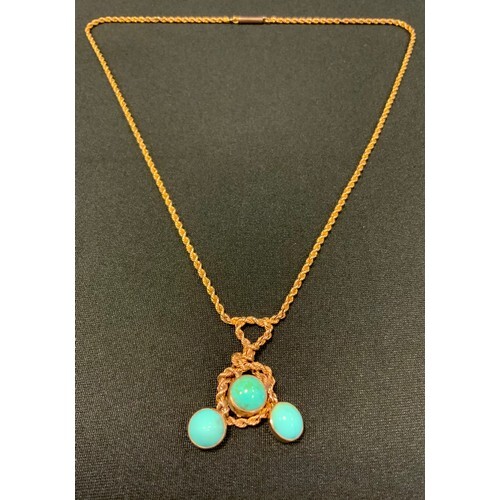A turquoise and gold coloured metal pendant necklace, the ro...