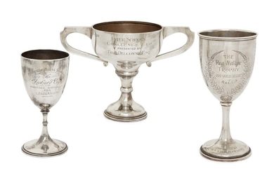 A twin-handled trophy cup, London, c.1933, Charles Kain, designed with wide angular handles and presentation engraving to body, 18.5cm high, together with two further silver trophy cups, 21 and 16.5cm high, both with presentation engraving, total...