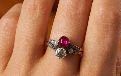 AN ANTIQUE AUSTRIAN BURMA NO HEAT RUBY AND DIAMOND RING in yellow gold, set with a cushion cut ruby