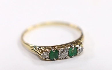 An 18ct, two stone emerald and three stone diamond set half ...