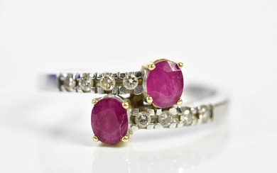 An 18ct white gold ruby and diamond crossover designed ring,...