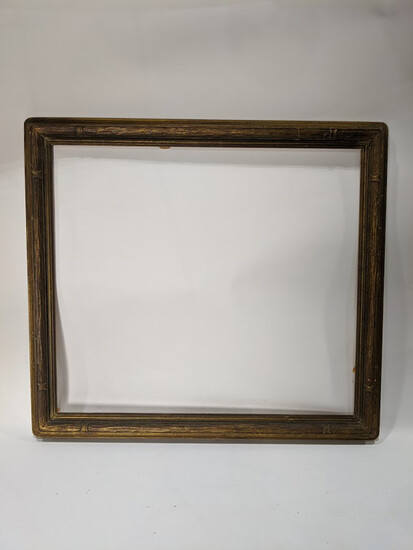 An Arts and Crafts giltwood carved picture frame