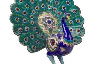 An Indian gilt-metal and meenakari enamel model of a peacock, 20th century, the tail, wings and base inset with paste jewels, perched on an oval base cast with flower-head border, 24cm high