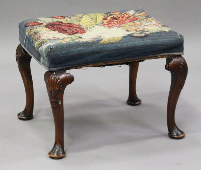An early 20th century Queen Anne style walnut stool, raised on shell-carved cabriole legs and pad fe