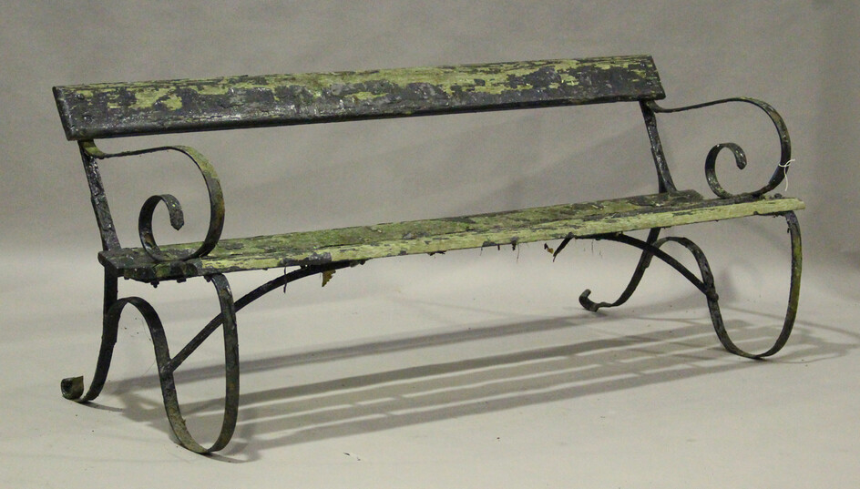 An early 20th century wrought iron scroll arm garden bench with slatted seat, height 74cm, width 185