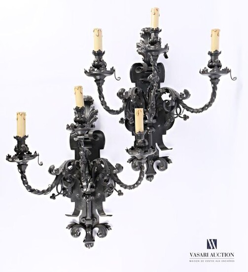 An important pair of wrought iron wall lights, the cut-out...