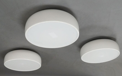 Jasper Morrison for Flos, a set of three 'Smithfield' ceiling lights, of recent manufacture, with domed white powder coated aluminium shades enclosing three lights, with injection moulded opalescent methacrylate diffuser, 22cm high, 60cm diameter...