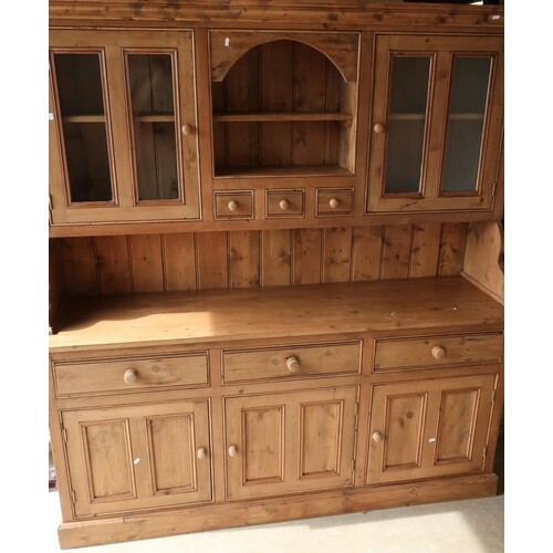 Large modern waxed pine dresser, the raised back with centra...