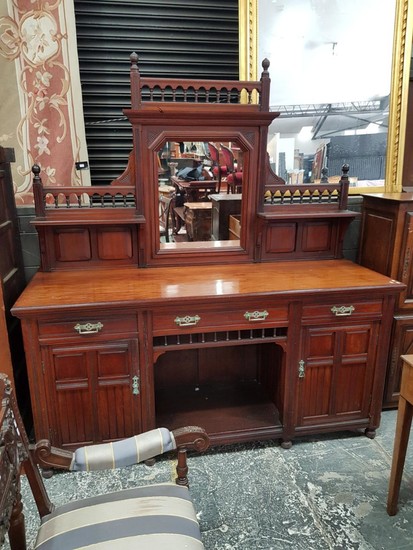 Late Victorian Walnut Sideboard, with central mirror flanked by shelves, above three drawers and alcove flanked by two panel doors