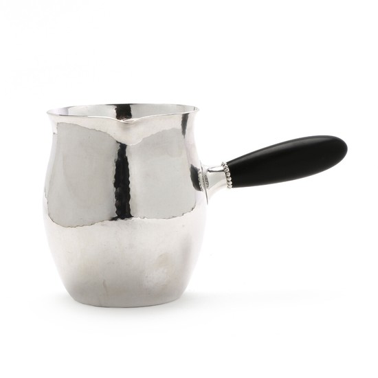 Milk pitcher/hot water pitcher of sterling silver with hammered surface and carved ebony handle. H. 11.7 cm.